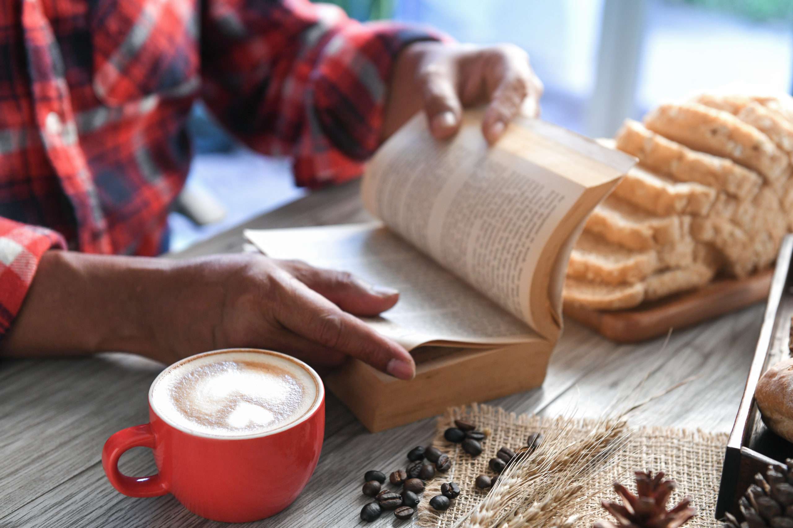 Man reading the book with coffee